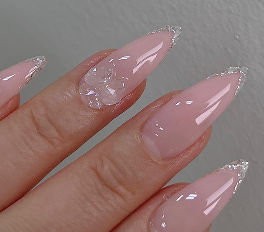 Sparkling pink acrylic nails with a touch of glitter, showcasing a premium Korean nail product from the NAILBAYO brand. The elegant and eye-catching design highlights the high-quality craftsmanship and attention to detail that the NAILBAYO Doi Tong gel #2 line is known for, making it a must-have accessory for fashion-conscious nail enthusiasts.