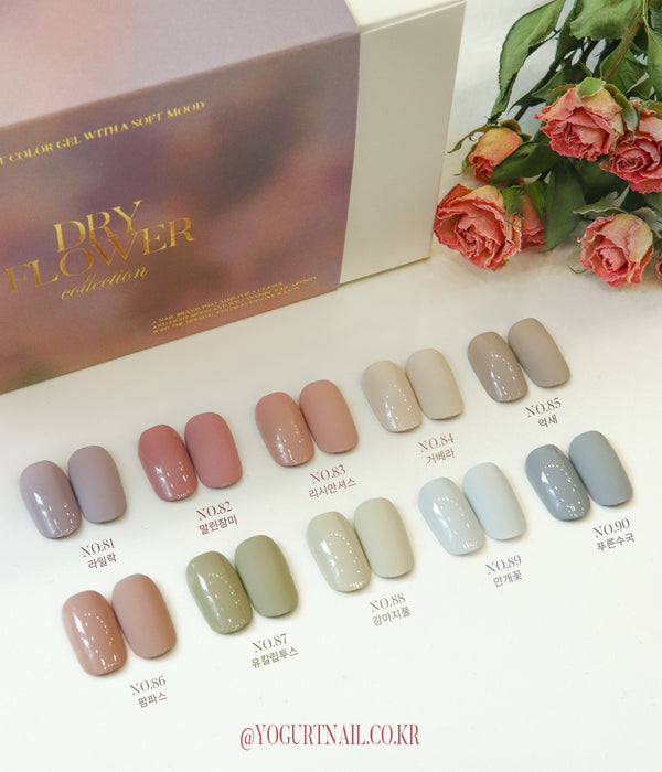 A colorful display of various nail polish shades, ranging from soft neutrals to vibrant pastels, showcasing the diverse "Yogurt" nail collection. The image prominently features a box labeled "YOGURT Grocery set 90 colors", hinting at the extensive color palette available in this product line.