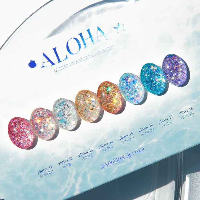 Vibrant and sparkling glitter gel polish collection from Yogurt Nail Kr. Aloha, capturing the essence of sun-kissed days with an array of tropical hues from blues to pinks. This expansive set features 8 long-lasting gel polishes and a color card, offering a vivid and eye-catching display of the brand's diverse color palette.