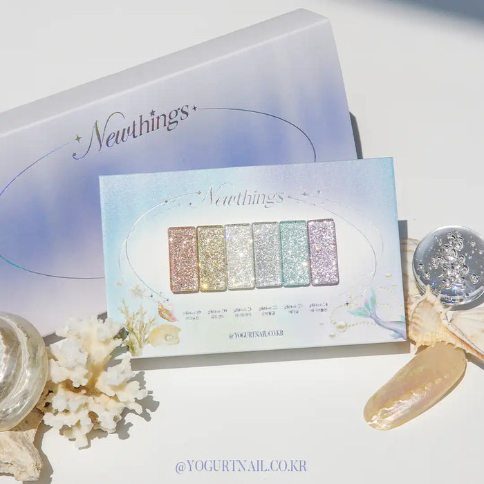 Detailed image of the Yogurt New Things Collection, showcasing 6 beautiful glitter gel polishes in various shimmering shades, including silver, gold, and pastel tones, against a soft, ethereal backdrop with nature-inspired elements, highlighting the collection's unique and trendy aesthetic. Yogurt Nail, Shopify.