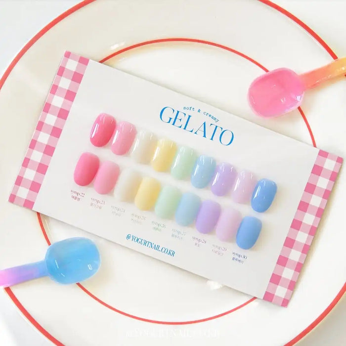 Vibrant and whimsical image showcasing the Yogurt Gelato Collection, a set of 9 piece syrup gels in a range of pastel colors. The gels are presented on a swatch card with a color chart, highlighting the variety of shades available. The product offers a mid-viscosity formula and limited edition boxed packaging for a complete and visually appealing set.