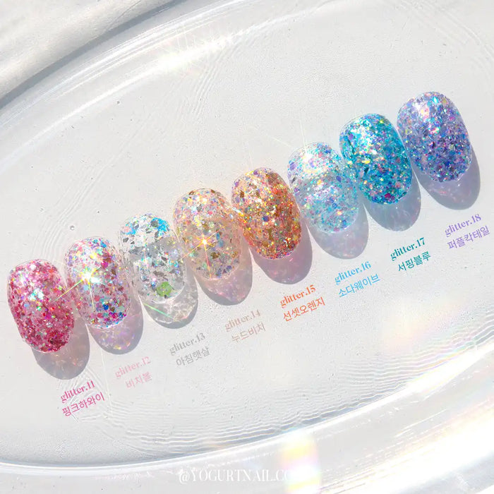 Vibrant and eye-catching image showcasing a diverse collection of colorful glitter gel nail polish bottles from the Yogurt Nail Kr. Aloha Collection. The polishes feature a range of captivating shades, from sparkling blues to tropical pinks, capturing the essence of sun-kissed days. This visually stunning Shopify product offers a long-lasting and vivid glittering experience that customers won't want to miss.