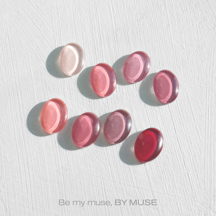 Elaborative Alt Text: A collection of 40 vibrant syrup gels and tinted syrups from the ByMuse "Be My Muse" line. The gels and syrups, which are HEMA-free, come in a range of pink and red hues, showcasing the brand's diverse and colorful product offerings. The image highlights the versatility and allure of the ByMuse nail care collection, inviting customers to explore and embrace their inner muse through these innovative and high-quality nail care