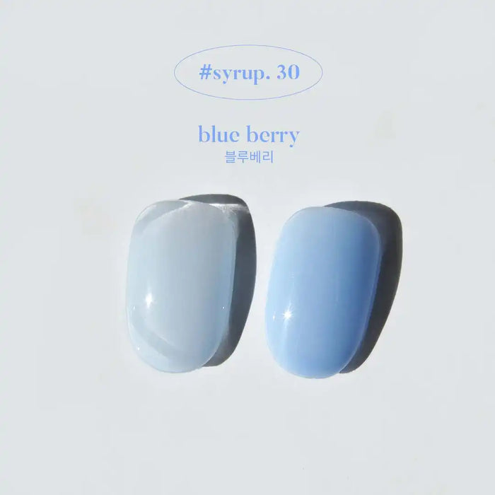 Detailed image of two gelato-colored bottles labeled "blue berry" and "#syrup.30", showcasing the vibrant and creamy hues of the Yogurt Gelato Collection by the brand.