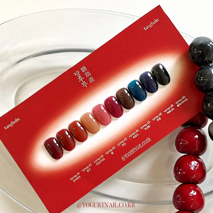 Vibrant and alluring display of Tanghulu Collection nail polish shades, showcasing a captivating range of deep, self-levelling gel-like hues inspired by the candied fruit delicacy. This comprehensive product swatch card allows discerning customers to carefully select the perfect shade to complement their Yogurt nail care regimen.