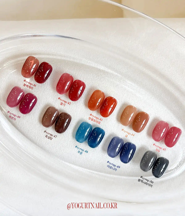 A vibrant collection of Yogurt nail polish shades, showcasing a diverse array of deep, self-leveling syrup tones reminiscent of candied fruit. The Tanghulu Single gel polish collection offers a wide range of color options, allowing customers to find the perfect shade. This Shopify product provides a 8ml volume per bottle and requires a 60-second UV/LED curing process for a long-lasting, professional finish.