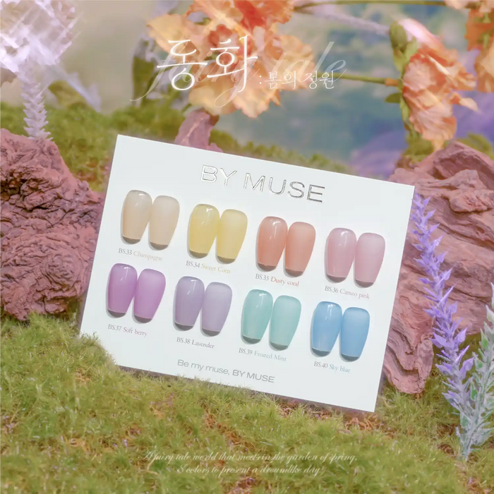 BY MUSE Fairy Tale Collection nail polish swatches displayed on a white card, showcasing eight pastel shades ranging from soft beige to delicate blue, surrounded by ethereal floral elements and greenery, evoking a dreamy spring garden atmosphere