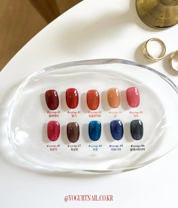 Detailed image showcasing the "YOGURT Tanghulu Collection" nail polish shades from the Shopify product line. The image displays 10 self-leveling syrup-like gel colors inspired by the candied fruit, Tanghulu. The product information includes the specific color numbers and names, as well as the 8ml bottle size and 60-second UV/LED curing instructions. This comprehensive visual aid helps customers easily identify and select the desired shade from th