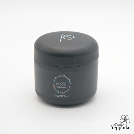 Sleek matte black cosmetic jar containing Adorelle Oui Clear gel, 50g/1.76oz. Minimalist design with white logo and text. Cylindrical container with flat top and bottom. Professional-looking packaging for high-end skincare or beauty product.