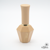 Elegant beige nail polish bottle from ADORELLE Romantic Vintage collection, featuring a unique hexagonal base and sleek cylindrical cap. The bottle showcases a refined design with gold lettering, embodying sophistication and timeless charm. Perfect for achieving a classic, romantic manicure look.