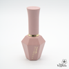 Elegant blush pink nail polish bottle with geometric faceted base and gold accent ring, featuring ADORELLE logo in gold lettering, part of the Romantic Vintage collection, showcasing sophisticated design and premium quality