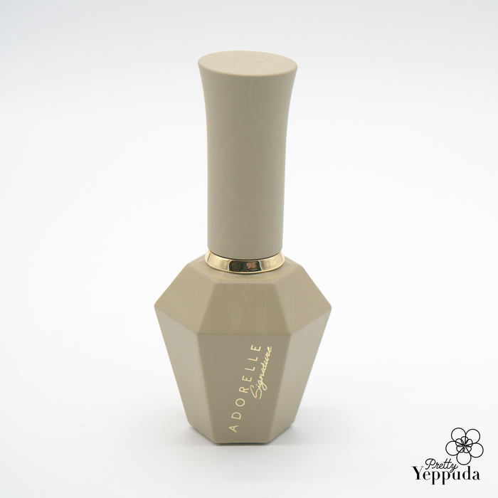 Elegant beige hexagonal nail polish bottle from ADORELLE Romantic Vintage collection, featuring a sleek cylindrical cap and gold accent ring, showcasing a sophisticated and timeless design perfect for creating classic manicures with a touch of vintage charm