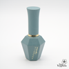 Elegant sage green nail polish bottle from ADORELLE Romantic Vintage collection. Hexagonal glass base with cylindrical cap and gold accent ring. Sophisticated design perfect for vintage-inspired manicures. Part of an 8-piece set of romantic, muted shades for timeless nail art.