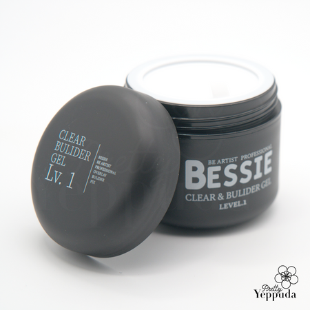 Bessie Clear and Builder Gel Level 1 in a sleek black container with white lid. The product name is prominently displayed on the jar, showcasing its professional-grade quality. This versatile nail gel offers both clear and building properties, perfect for creating strong, beautiful nails. Part of the extensive Bessie collection, ideal for nail artists and enthusiasts alike.