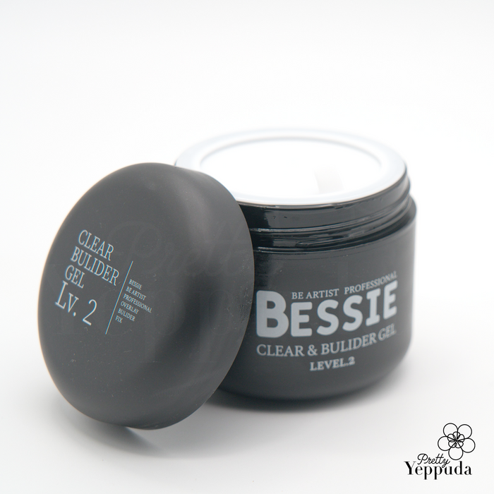 Sleek black jar of Bessie Clear and Builder Gel Level 2, featuring 50g of professional nail enhancement product. The container has a matte finish with elegant white text, showcasing the brand name and product details. The lid is partially open, revealing the pure white gel inside, ready for application in nail art and extensions.