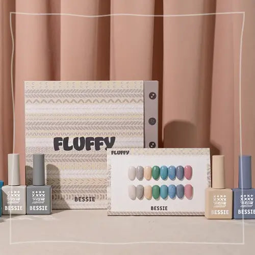 A set of 8 fluffy, pastel-colored nail polish bottles arranged neatly on a white backdrop, showcasing the BESSIE brand's winter-themed "Fluffy Collection" of nail products.