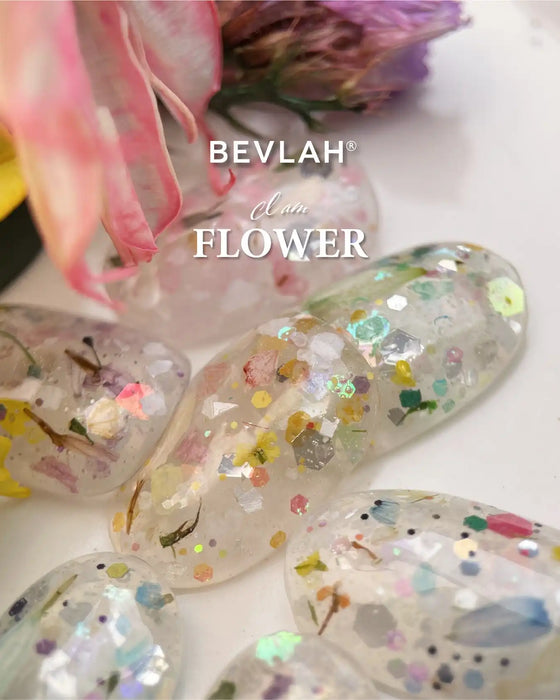 The vibrant, eye-catching BEVLAH I Am Flower Petal Collection showcases a stunning array of over 70 real flowers and sparkling glitters, creating a truly dazzling and moist visual experience. This unique and diverse floral ensemble, with its varied size, shape, and type, offers a one-of-a-kind product that celebrates the beauty and diversity of nature. The set includes 7 flower gels and 1 free dawn dew part, all free of harsh chemicals, making it