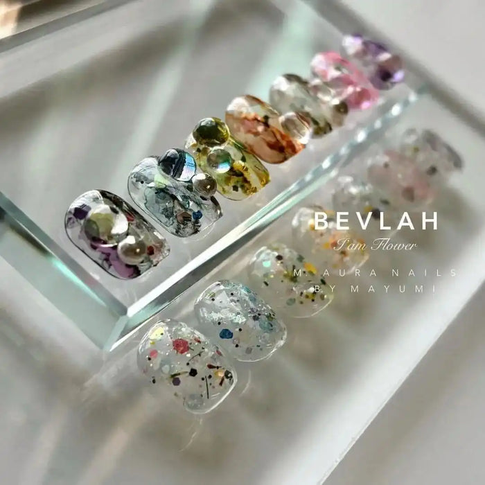 Detailed image of a Shopify product titled "BEVLAH I Am Flower", showcasing a dazzling and moist Petal Collection featuring a blend of over 70 real flowers and glitters. The set contains 7 flower gels and 1 free dawn dew part, offering a unique and diverse floral experience for the user.