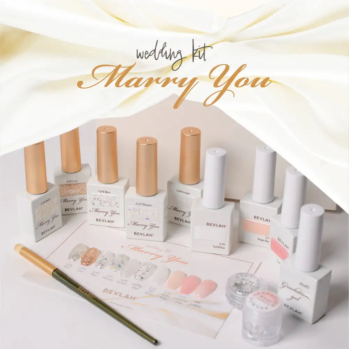 The image depicts a variety of nail polish bottles, brushes, and other nail care products in a wedding-themed kit called "Marry You" by the BEVLAH brand. The products appear to be designed for creating the perfect studio or wedding nails, with sheer skin-tone colors, glitter, wedding stones, and gradient effects. The kit is highlighted as HEMA-free and containing various beneficial ingredients.