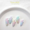 Five stiletto-shaped nails decorated with gradient pastel colors from the BY MUSE Smoothie Fresh Pastel Tone Collection. The nails feature an ombre effect in pastel tones with white, drip-like designs on the tips. The colors transition smoothly, creating a soft, dreamy look with a glossy finish.