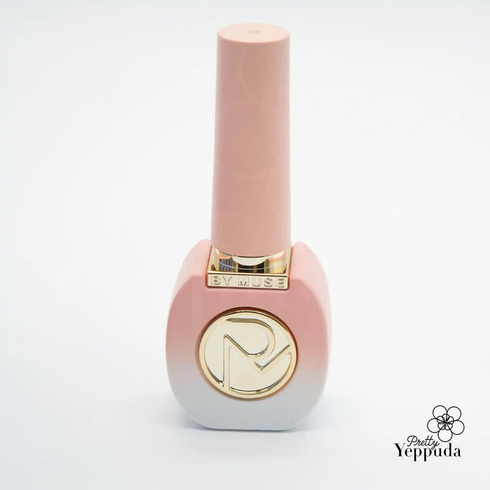 A beautifully crafted gel nail polish bottle from the ByMuse 40pc syrup gel collection, featuring a sleek, modern design with a pink hue and a gold logo embellishment, showcasing the brand's commitment to high-quality, HEMA-free nail care products that can be cured with 60s UV/LED technology.