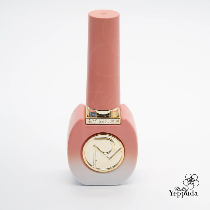 A close-up image of a peach-colored nail polish bottle featuring the ByMuse brand name and logo, showcasing the sleek and modern design of this Shopify product.