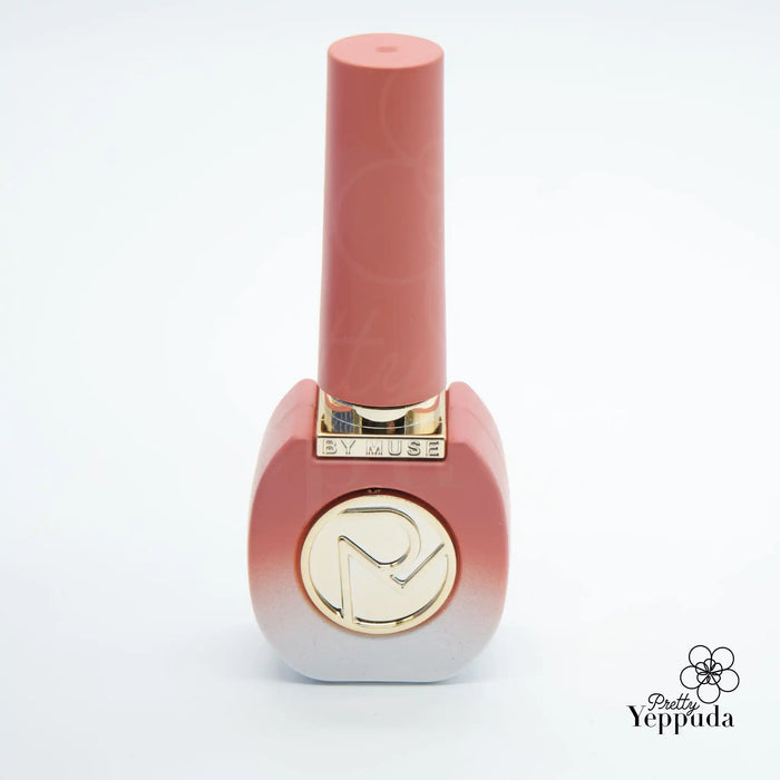 Elegant and vibrant gel nail polish bottle in a soft, muted pink hue, featuring the ByMuse brand logo prominently displayed, showcasing the high-quality, HEMA-free "Be My Muse" 40-piece syrup gel collection.