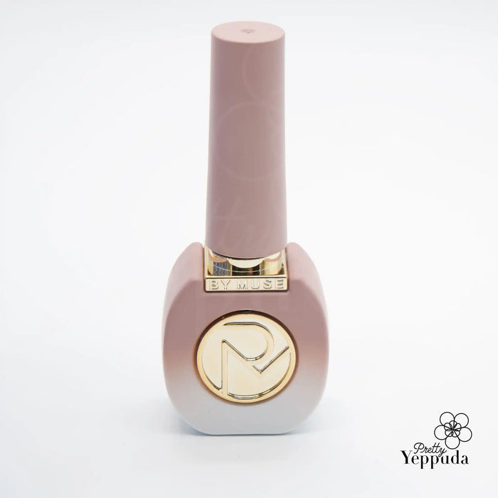 The image appears to be a nail polish bottle from the ByMuse brand. The bottle is a soft pink color with a gold logo on the cap, featuring a stylized "M" design. The product is part of the ByMuse 40pc syrup gel collection, which includes 32 syrup gels and 8 tinted syrups that are HEMA-free and can be cured with 60s UV/LED.