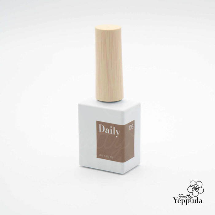 Elegant nail polish bottle in warm autumn shades, showcasing the DAILY 'WOODY' Collection by a Shopify beauty brand. Features a range of cozy, nature-inspired hues from delicate pinks to deep maroons, designed to capture the essence of the fall season.