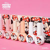 Detailed alt text: The image shows a collection of 10 Minnie Mouse-themed gel nail polish bottles arranged in a row against a vibrant pink background. The bottles feature various Minnie Mouse-inspired designs, including polka dots, bows, and Minnie's iconic silhouette. The product is part of the DGEL Disney Minnie Mouse Collection, offering a range of nude, floral, and blush-toned shades. The bottles showcase the buildable, opaque formula and smo