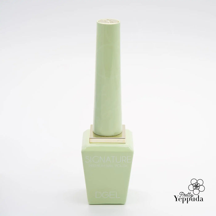 Delicate and whimsical gel polish bottle in a pastel green shade, evoking the playful and sweet scent of cotton candy from the DGEL Signature Cotton Candy Collection. The sleek and minimalist design exudes a sense of sophistication and elegance, perfect for creating a dreamy and joyful manicure experience.