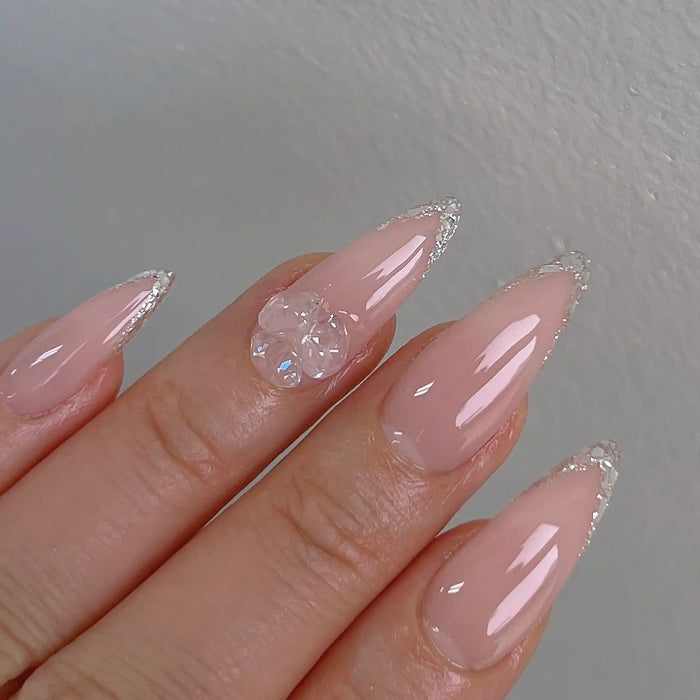 Elegant and delicate gel nail design featuring soft pink color and sparkling crystal accents, showcasing a premium Korean nail product by the renowned brand NAILBAYO.