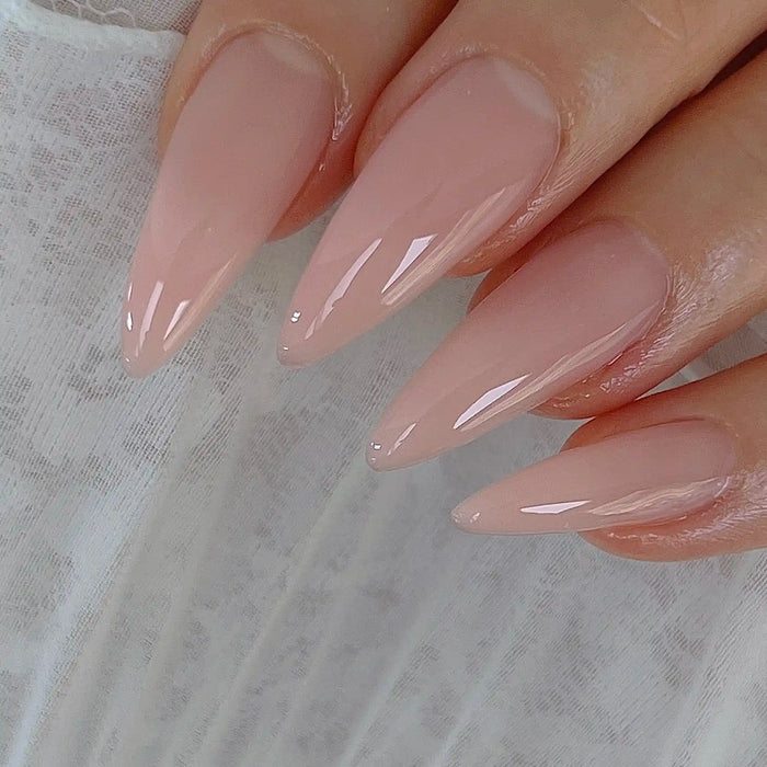 Elegant and sleek nude-colored gel nails with a high-shine finish, showcasing the sophisticated design and color palette of the "Nailbayo DOI Aube #02 - 10ml" Korean nail product. The image highlights the product's key features, including its HEMA-free formulation and use by renowned Korean nail artist Nailbayo.