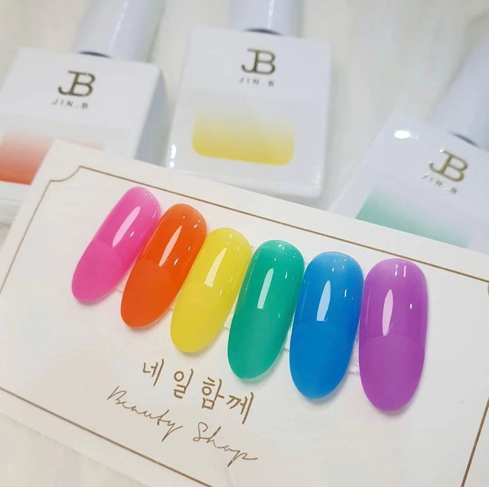 Vibrant, colorful nail polish bottles showcasing the diverse "Candy Pop Collection" from the JIN.B brand, offering a range of syrup gel polishes in a variety of captivating hues.