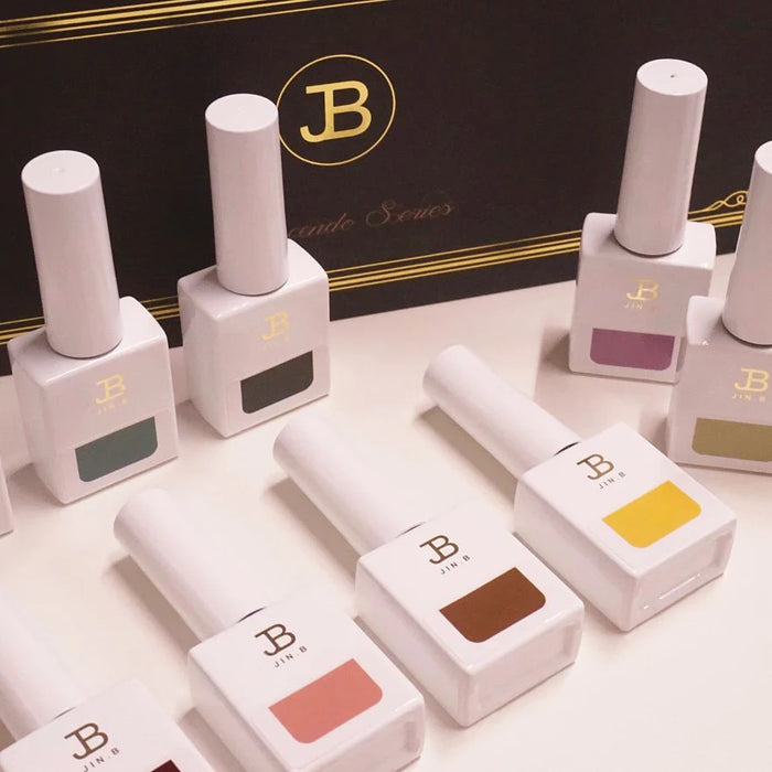 A sophisticated set of high-end nail polish bottles in the Gracia JIN.B Crescendo Series, featuring a bold and modern monogram design. The 10-piece set showcases a range of vibrant colors, each bottle containing 11ml of premium formula. This premium nail care product line offers a luxurious and elevated nail care experience for discerning Shopify customers.