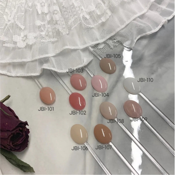 Ten syrup gel samples labeled with JBI product IDs, displayed alongside a white ruffled fabric and a purple rose, showcasing the variety of color options available in the JIN.B Pianissimo Syrup Gel Set.