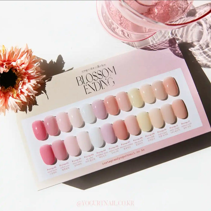 A close-up image of a Shopify product called 'YOGURT Blossom Ending Collection 12 syrup gels'. The image shows a swatch card displaying various shades of pink, nude, and light-colored nail gel polishes. A floral accent and glassware are visible in the background, adding to the aesthetic appeal of the product.