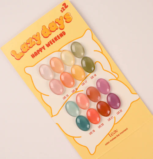 Vibrant and whimsical assortment of colorful, sheer syrup gel nail polish shades in the Leav Lazy Days Collection, showcasing a diverse palette of warm, deep hues perfect for relaxing weekend manicures.