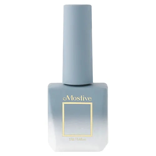 A close-up image of a gray nail polish bottle with the Mostive brand name prominently displayed in gold lettering. The bottle features a simple and elegant design, perfectly encapsulating the essence of the Mostive Muesli Muse Collection. This product offers a delicate, transitional color palette that seamlessly bridges the gap between summer and autumn, making it a versatile and must-have addition to any Mostive enthusiast's collection.