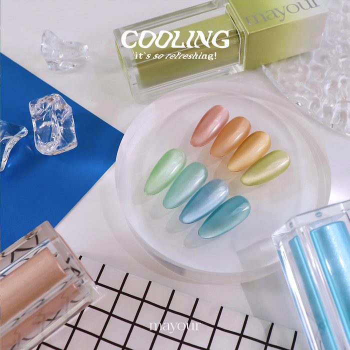 A vibrant display of a nail polish collection showcasing a variety of cool, icy hues. The image highlights the diverse palette of colors, including shimmering magnetic glitters that give a refreshing, frost-like effect to the nails. This MAYOUR Cooling Collection offers a stylish and rejuvenating nail care experience, perfect for any season.