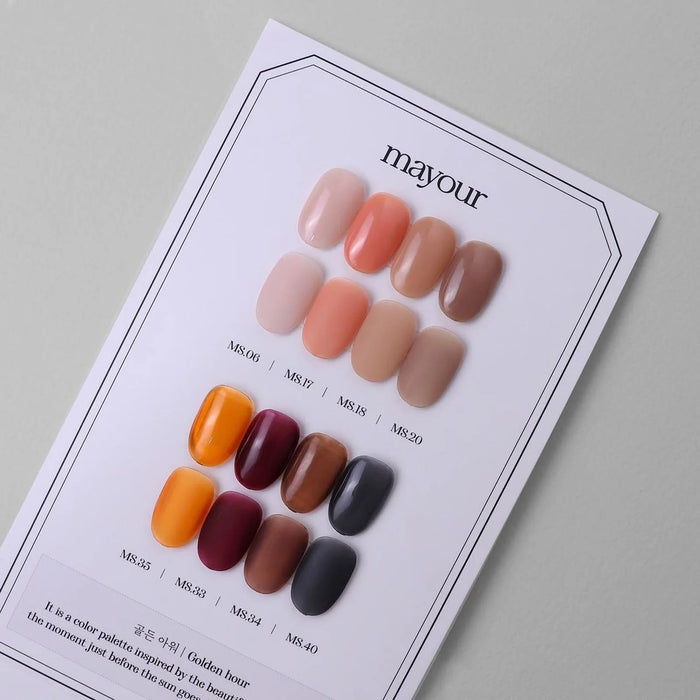 Detailed image showcasing the vibrant and warm-toned shades of the MAYOUR Golden Hour Collection, a comprehensive 8-piece nail polish set that captures the enchanting colors of the sunset. Each gel polish offers vivid pigmentation, quick-drying capabilities, and versatility for creating stunning nail art designs.