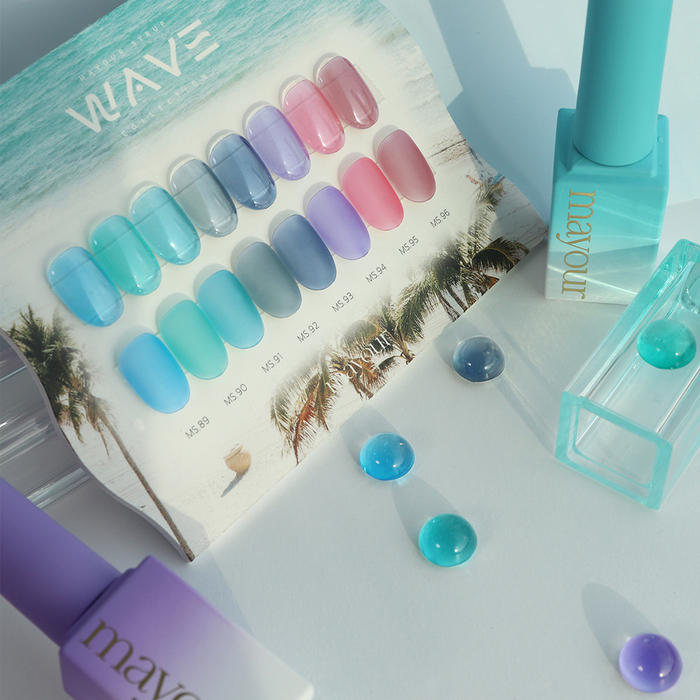 Eight vibrant, ocean-inspired gel polish shades from the MAYOUR Wave Collection, featuring a variety of tranquil blues, calming lavenders, and shimmering coastal hues, designed to capture the essence of summer and elevate your nail art with a jelly syrup formula for creative, trendy manicures.