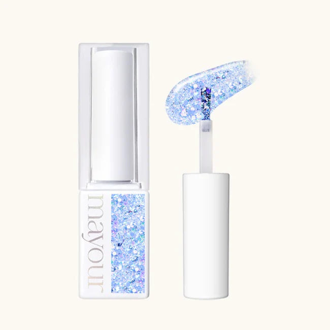 Descriptive alt text for the image: A set of two iridescent gel products from the MAYOUR Lolly Shop Collection. The larger product is a clear glass jar with a white lid, containing a gel-like substance with shimmering blue and purple glitters. The smaller product is a miniature version of the larger one, showcasing the shimmering, translucent gel formula with holographic glitter inclusions. These decadent and sugary-looking products are designed 