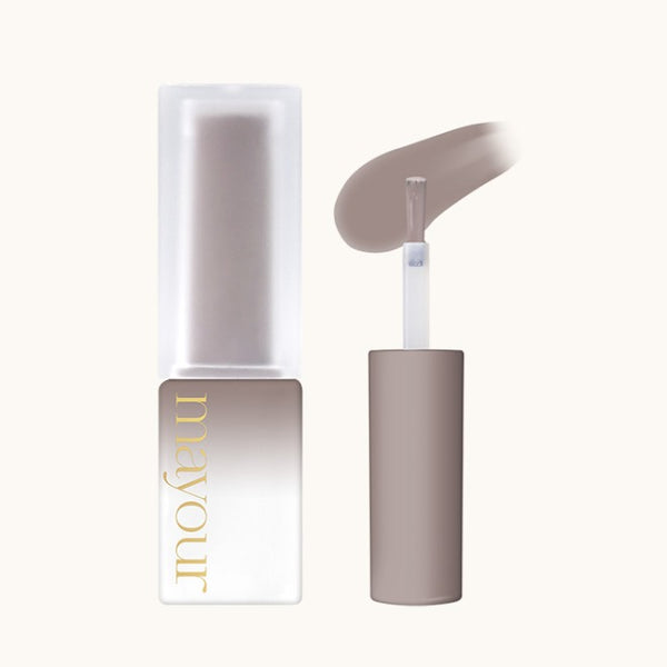 Elegant MAYOUR syrup gel bottle and applicator showcasing a luxurious taupe shade. White and gold branding visible on the sleek, minimalist packaging. Smooth texture of the gel demonstrated with a graceful swoop, highlighting its high-quality formulation and versatility for nail art and crafts.