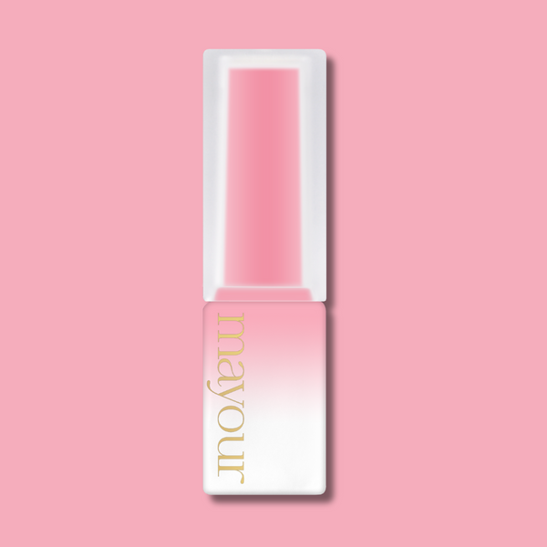 Elegant MAYOUR nail polish bottle in soft pink and white gradient design with gold lettering, showcasing a luxurious syrup gel polish from The Collector Season 2 set, positioned on a pastel pink background for a stylish and feminine product presentation