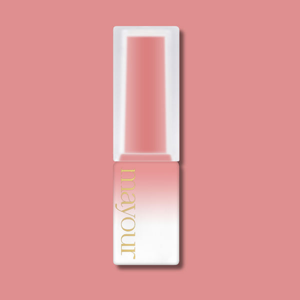 Elegant MAYOUR syrup gel polish bottle in white and pink gradient design, featuring gold branding, on a soft pink background, showcasing the luxurious and versatile nature of The Collector Season 2 nail polish collection