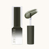 MAYOUR The Collector Season 3 gel polish bottle in dark olive green, showcasing sleek packaging with white branding. Applicator brush visible, demonstrating the smooth, rich texture of the syrup gel lacquer. Part of a versatile 40-piece set for creating stunning nail art designs.