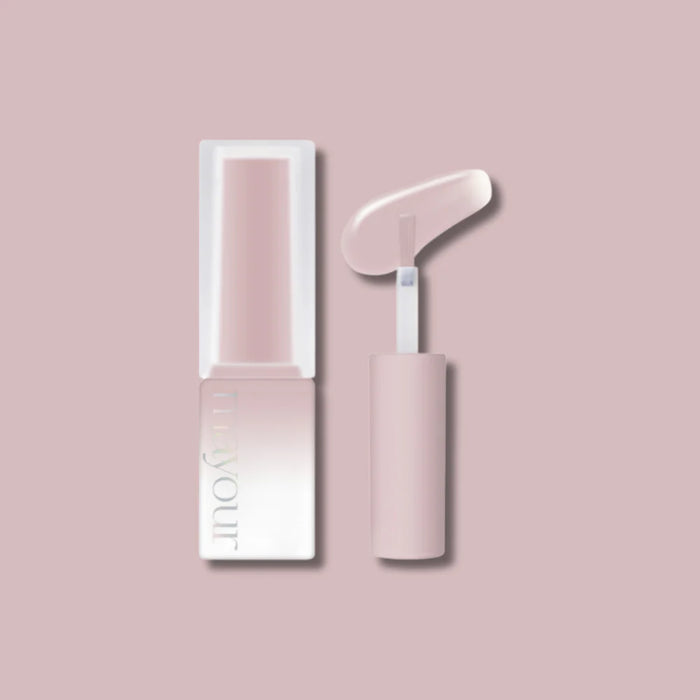 Elegant pastel-colored cosmetic products from the MAYOUR Grooming Collection, including a lipstick or nail polish and an applicator tool, presented against a soft pink background.