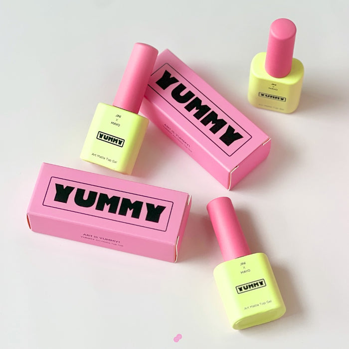 Vibrant and whimsical MAYO JINI Yummy Matte Top Gel product image, featuring the pink and yellow packaging that showcases the playful collaboration between the brands.