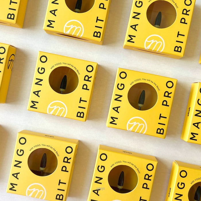 The image shows multiple packages of the "YOGO Mango Bit [Softcon Pro Bit]" product, with the brand logo and product name prominently displayed on the yellow packaging. The product appears to be a versatile nail care tool designed for smooth gel removal without discomfort.